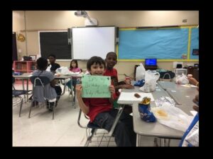 Kids in classroom with birthday sign