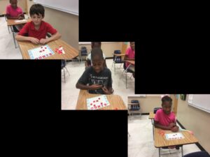 Children playing bingo in a classroom.