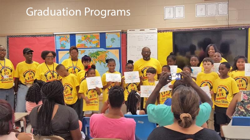 Children holding certificates at graduation ceremony.